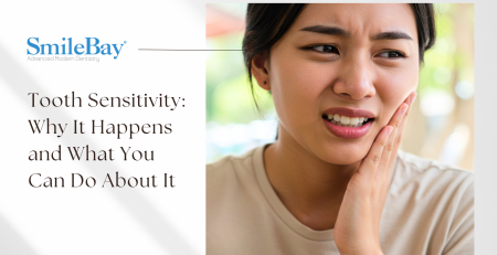 Woman touching her cheek in discomfort due to tooth sensitivity