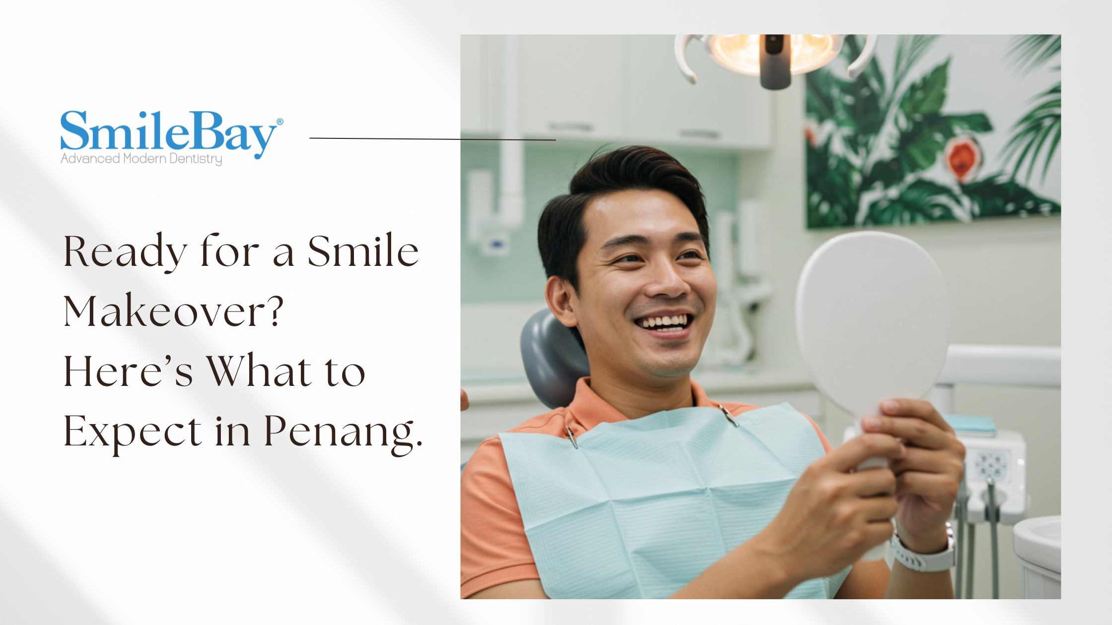 Smiling male patient looking into a mirror after smile makeover consultation at SmileBay Dental Penang